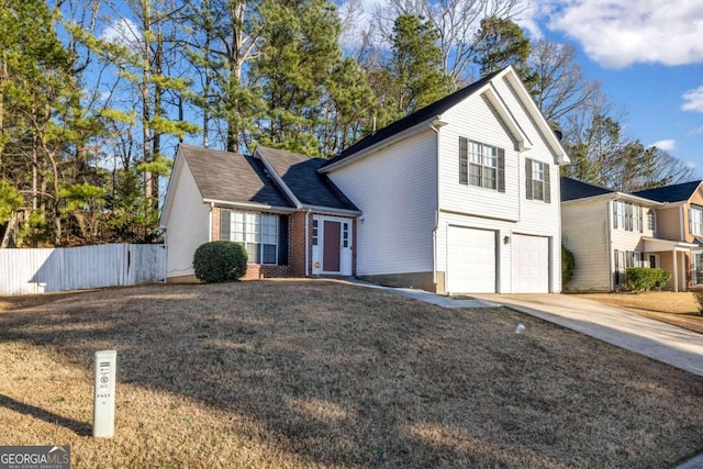 view of property with a garage and a front yard