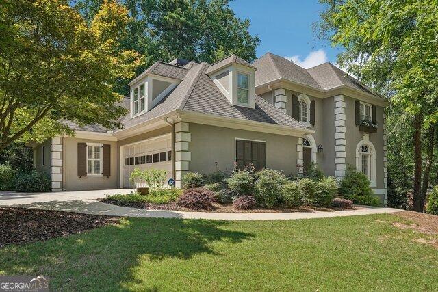 view of front facade with a garage and a front lawn