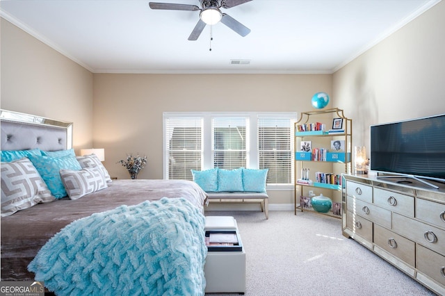 bedroom with ceiling fan, ornamental molding, and carpet floors