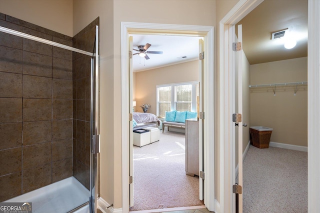 bathroom with ceiling fan and a shower with door