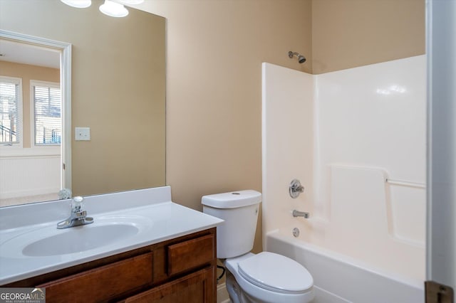 full bathroom with vanity, washtub / shower combination, and toilet