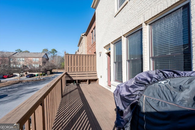 wooden balcony featuring a wooden deck and area for grilling