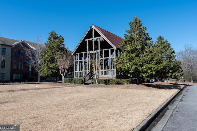 view of front of property featuring a sunroom