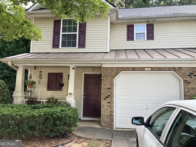 view of front of home featuring a garage and a porch