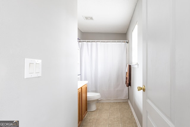 full bathroom featuring vanity, a shower with curtain, visible vents, tile patterned flooring, and toilet