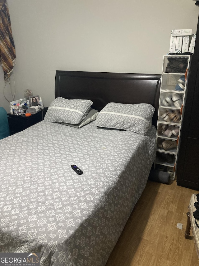 bedroom with hardwood / wood-style floors