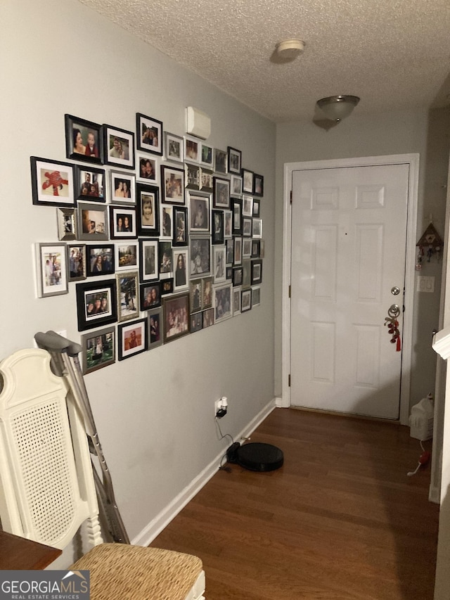 entryway featuring dark hardwood / wood-style floors and a textured ceiling