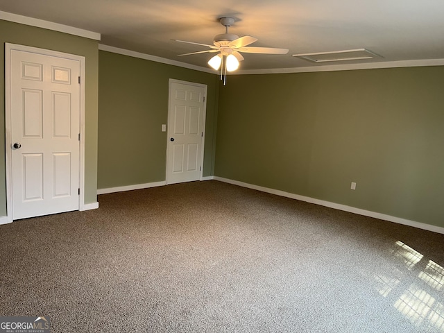 empty room with crown molding, ceiling fan, and carpet floors