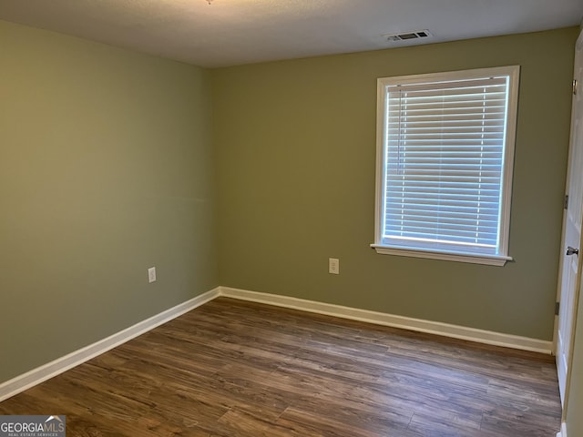 empty room featuring dark hardwood / wood-style flooring