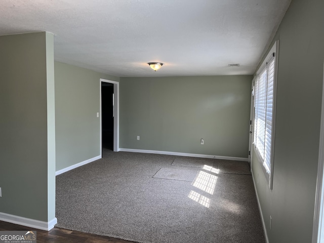 carpeted spare room with a textured ceiling