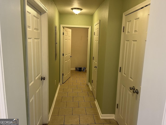 hall featuring dark tile patterned floors