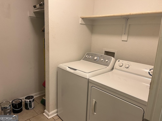 washroom with light tile patterned flooring and washer and clothes dryer