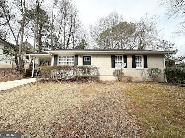 ranch-style home with a front lawn and a carport