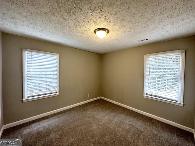 spare room with carpet floors and a textured ceiling