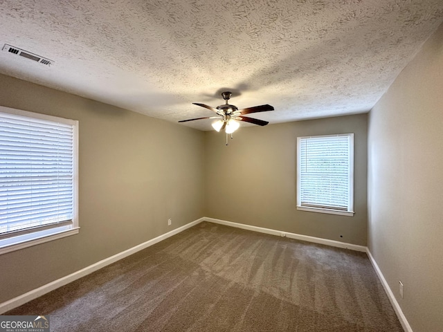 carpeted empty room featuring a textured ceiling and ceiling fan