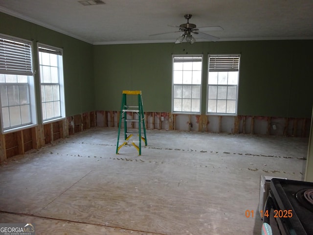 interior space with ornamental molding and ceiling fan