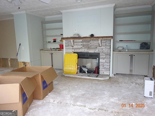 unfurnished living room with ornamental molding and a stone fireplace