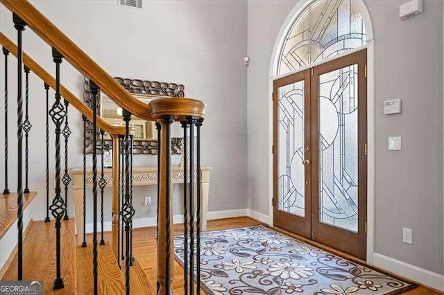 entrance foyer featuring french doors and light hardwood / wood-style floors