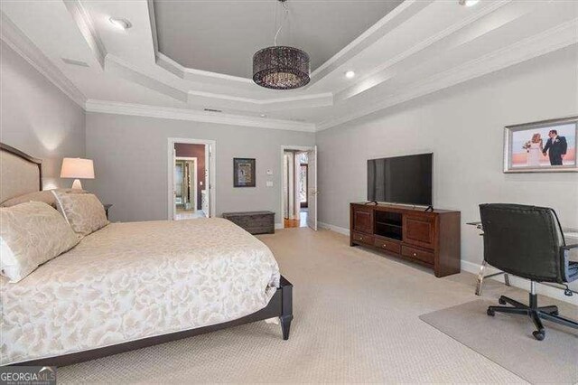 bedroom with crown molding, a tray ceiling, and light carpet