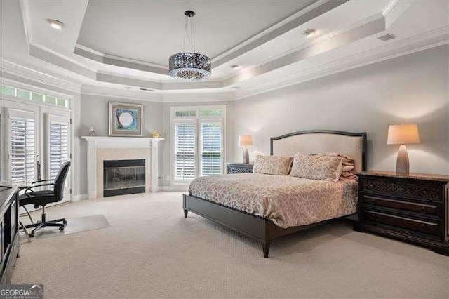 carpeted bedroom featuring a raised ceiling, crown molding, and a chandelier