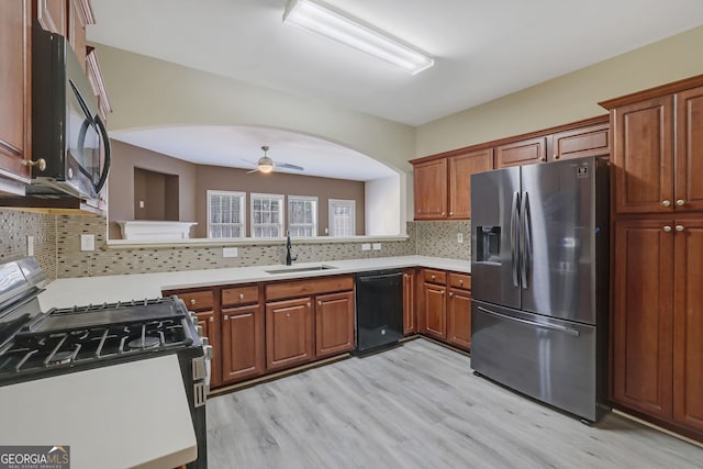 kitchen with sink, backsplash, black appliances, and ceiling fan