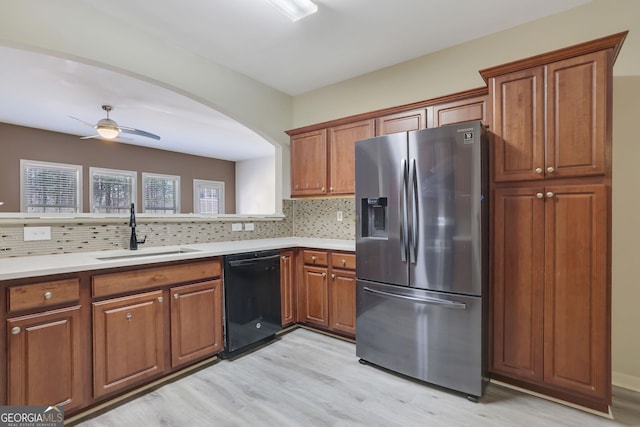 kitchen with sink, black dishwasher, stainless steel refrigerator with ice dispenser, and backsplash