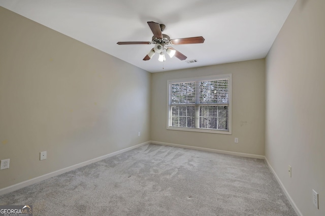 unfurnished room with ceiling fan and light carpet