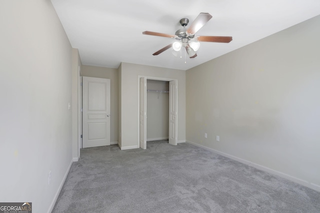 unfurnished bedroom with light carpet, ceiling fan, and a closet