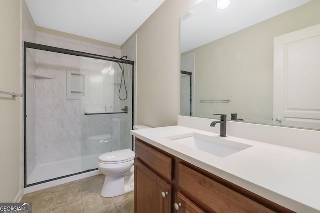 bathroom with tile patterned floors, toilet, vanity, and an enclosed shower