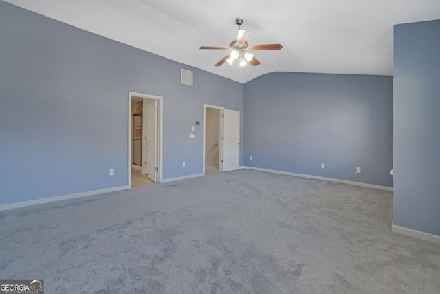 interior space featuring light carpet, vaulted ceiling, ceiling fan, and connected bathroom