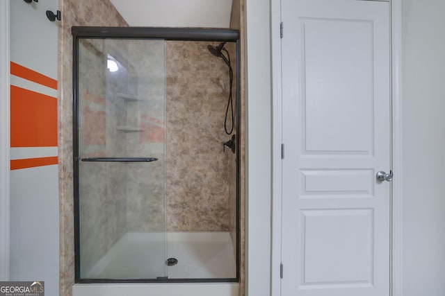 bathroom featuring a shower with shower door