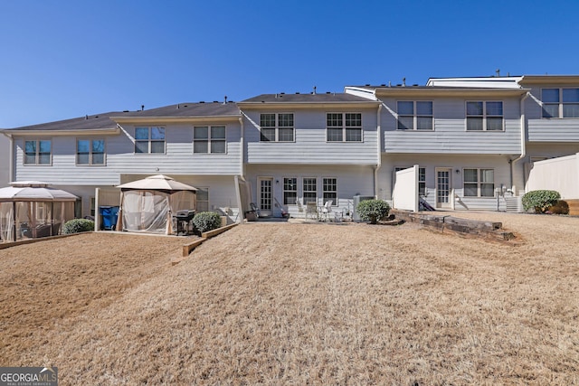 back of property with a patio and a gazebo