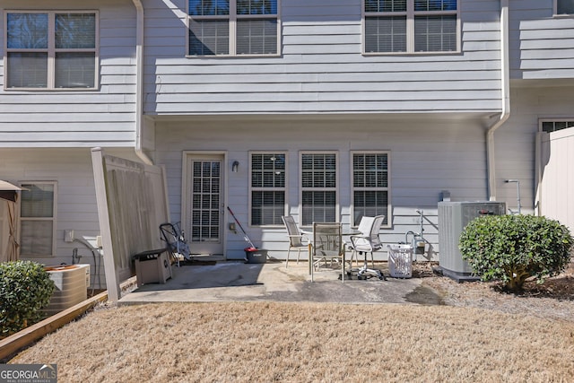 back of property with a patio area and central air condition unit