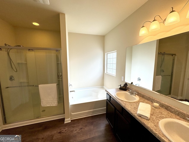 bathroom featuring vanity, hardwood / wood-style floors, and independent shower and bath