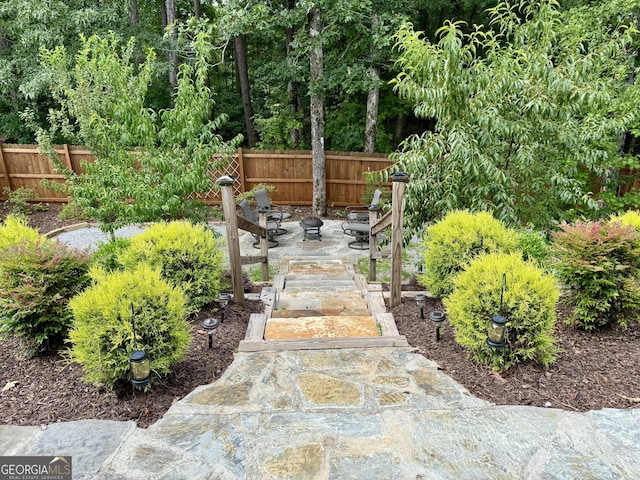 view of yard featuring a patio and a fire pit