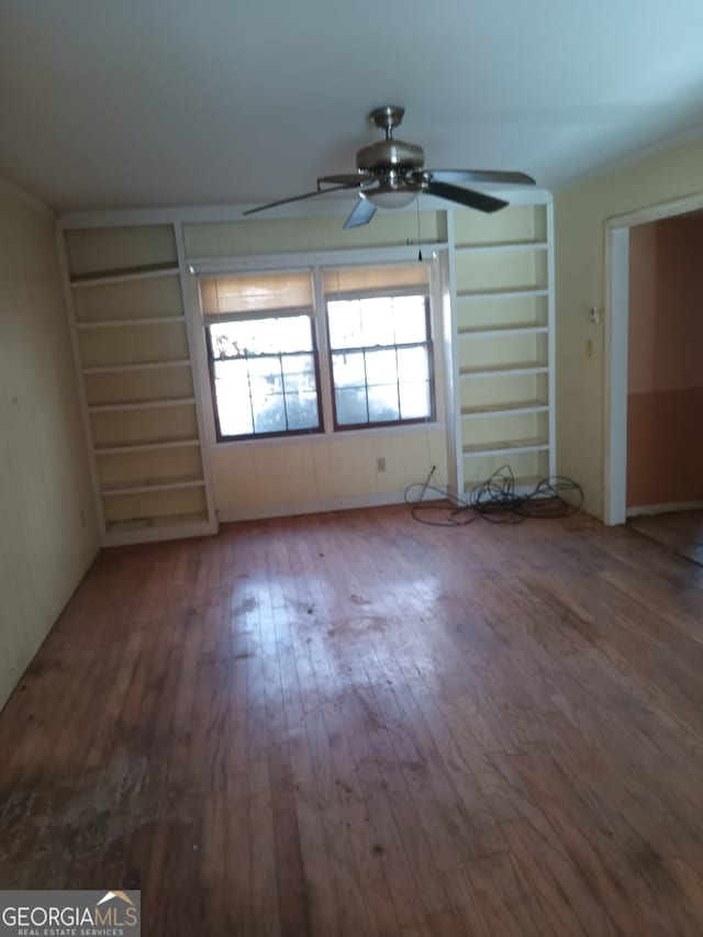 unfurnished room featuring hardwood / wood-style flooring and ceiling fan