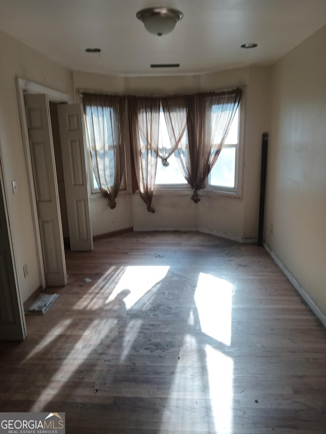 spare room featuring hardwood / wood-style floors