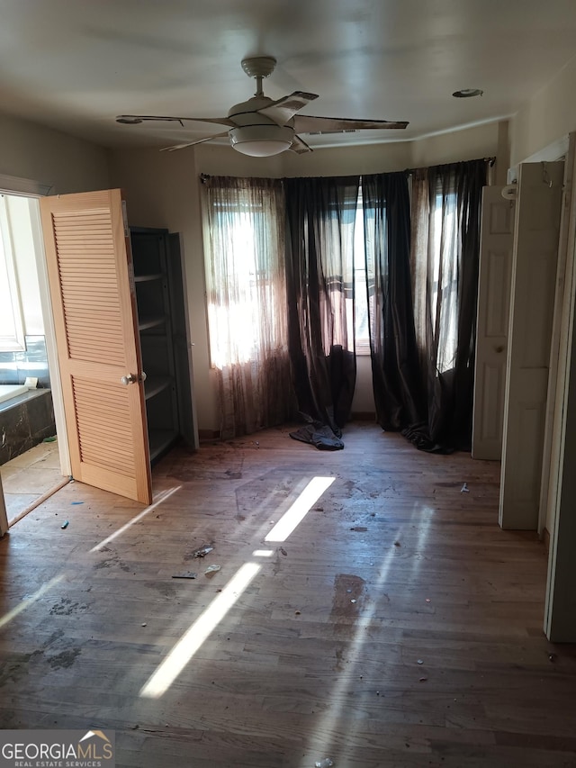 unfurnished bedroom featuring ceiling fan and wood-type flooring