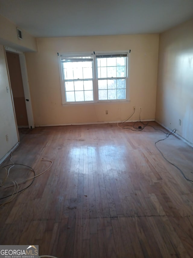 empty room with hardwood / wood-style flooring