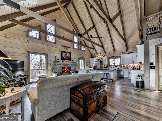 living room with dark hardwood / wood-style floors, a stone fireplace, wooden ceiling, beamed ceiling, and wood walls