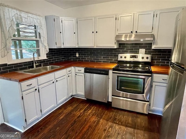 kitchen featuring stainless steel appliances, white cabinetry, sink, and butcher block countertops