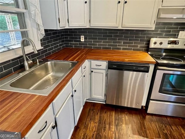 kitchen featuring white cabinetry, stainless steel appliances, sink, and butcher block countertops