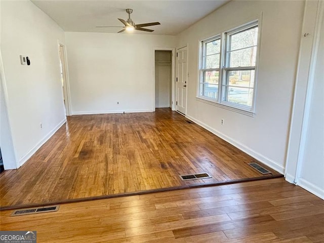 empty room featuring hardwood / wood-style flooring and ceiling fan