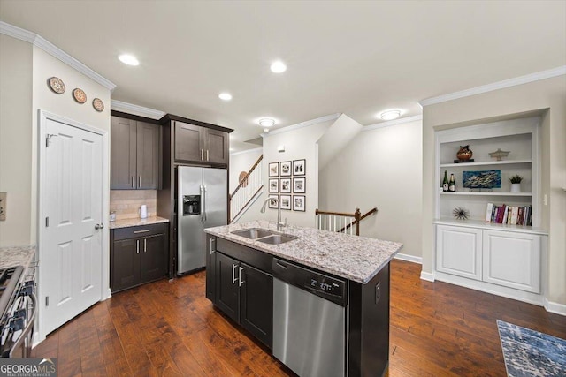 kitchen featuring sink, a center island with sink, dark hardwood / wood-style floors, stainless steel appliances, and light stone countertops