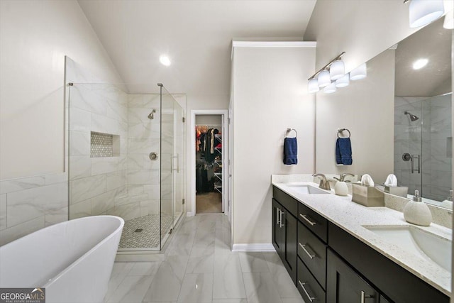 bathroom with independent shower and bath, vaulted ceiling, and vanity