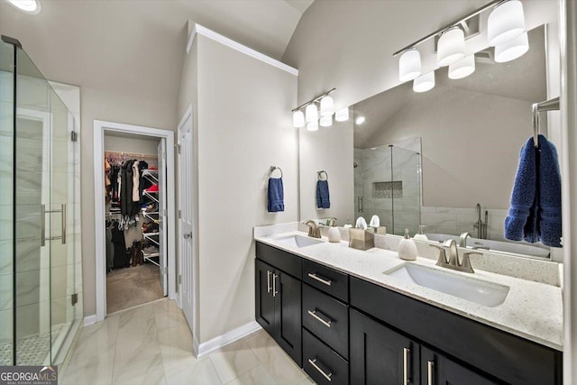 bathroom with vanity, lofted ceiling, and a shower with shower door