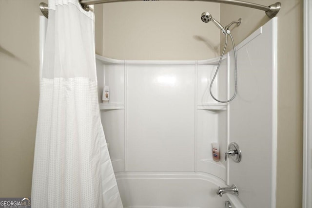 bathroom with shower / bath combo with shower curtain