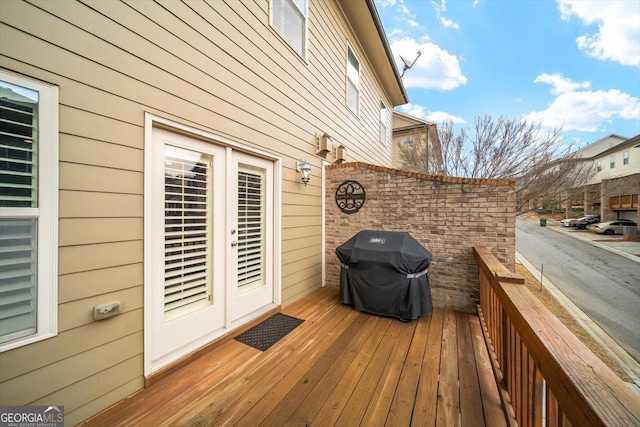 wooden terrace featuring area for grilling and french doors