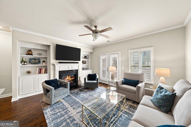 living room with crown molding, dark hardwood / wood-style floors, built in features, and ceiling fan