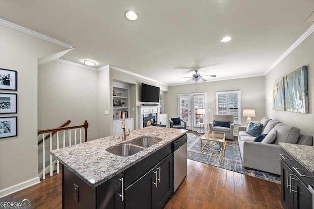 kitchen featuring dark hardwood / wood-style floors, sink, ornamental molding, a kitchen island with sink, and stainless steel dishwasher